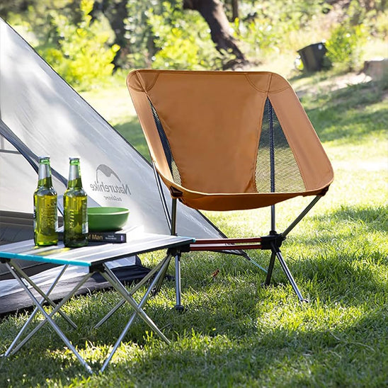 chaie camping kaki a coté d'une table et deux bières