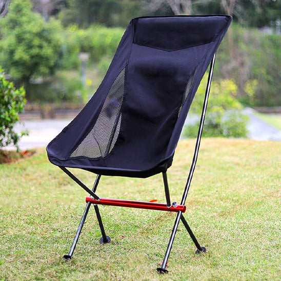 chaise de camping noir avec un long dossier sur le gazon