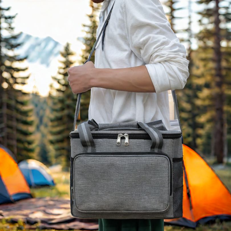 homme-qui-porte-une-glaciere-souple-sur-terrain-de-camping