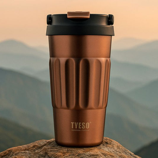 un mug café isotherme couleur or sur rocher