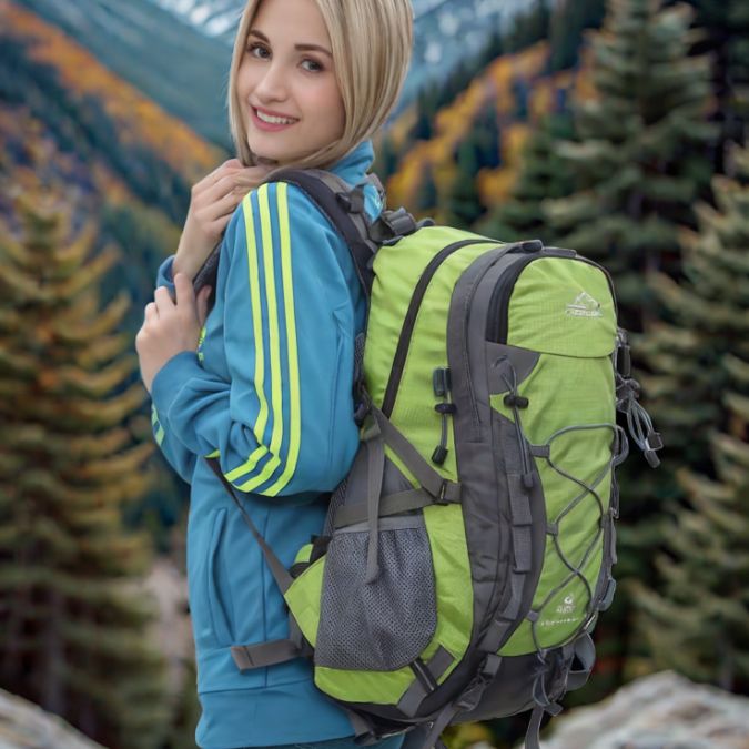 femme-souriante-avec-un-sac-a-dos-40l-vert-en-forêt