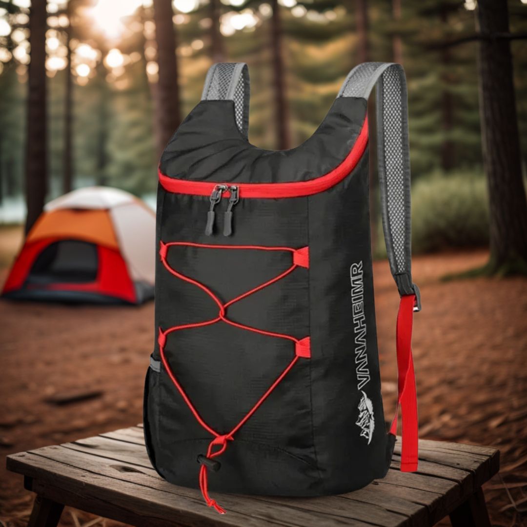 sac-à-dos-pliable-noir-et-rouge-sur-une-table-de-camping-avec-une-tente