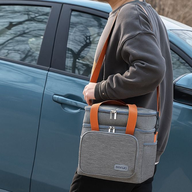 homme marchant proche d'un véhicule avec un sac isotherme gris accroché à l'épaule